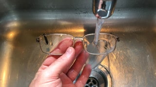 washing eyeglasses in the sink with alcohol-free eyeglass cleaner