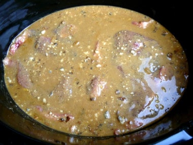 pork chops covered with a beefy-mushroom gravy inside a Crock Pot slow cooker