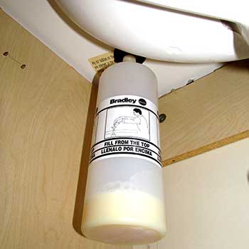 under-cabinet view of a soap dispenser container