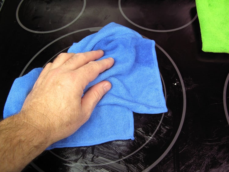 cleaning a glass-top stove with a Sollievo microfiber kitchen cloth