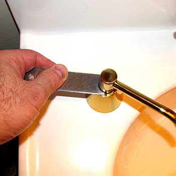 tightening the escutcheon on a soap dispenser